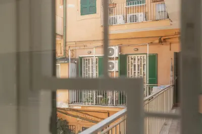 a view from a window of a building with green shutters at La Dolce Vita - Elegant retreat in the heart of Rome in Rome