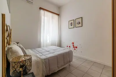 a bedroom with a bed and a window at GuestHost - Comfy Apartment X2 in Monteverde in Rome