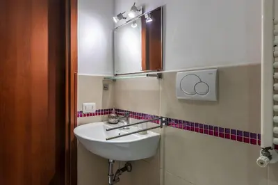 a bathroom with a sink and a mirror at GuestHost - Comfy Apartment X2 in Monteverde in Rome