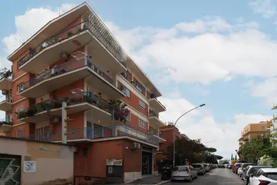 a building with balconies and cars parked on a street at GuestHost - Comfy Apartment X2 in Monteverde in Rome