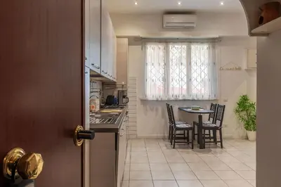 a kitchen and dining room with a table and chairs at GuestHost - Comfy Apartment X2 in Monteverde in Rome