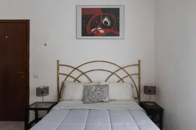 a bed in a room with two lamps and a picture at GuestHost - Comfy Apartment X2 in Monteverde in Rome