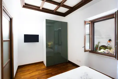a glass door in a room with a window at Vicolo Trevi Apartment by Rental in Rome in Rome
