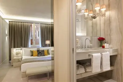 a bedroom with a bed and a sink and a mirror at Saphir Luxury Apartment in Rome