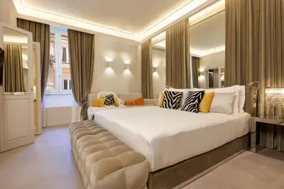 a bedroom with a large white bed and a couch at Saphir Luxury Apartment in Rome