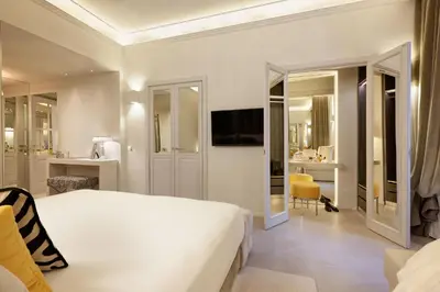a bedroom with a white bed and a bathroom at Saphir Luxury Apartment in Rome