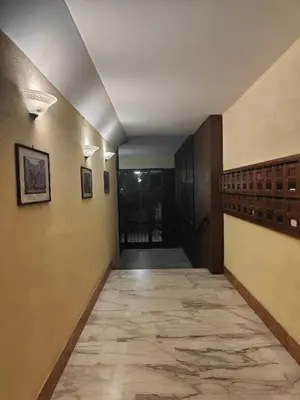 a hallway with a tile floor in a building at Large Apartment in Garbatella Near the Center of Rome in Rome
