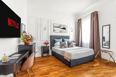 a hotel room with a bed and a desk and a desk at Blue Prestige Suites in Rome