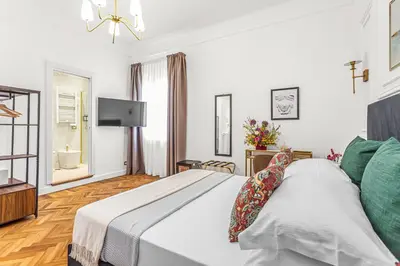 a bedroom with a bed and a flat screen tv at Blue Prestige Suites in Rome