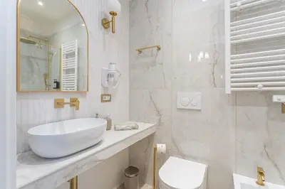 a white bathroom with a sink and a toilet at Blue Prestige Suites in Rome