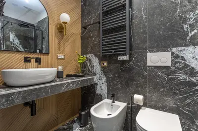 a bathroom with a sink and a toilet and a mirror at Blue Prestige Suites in Rome
