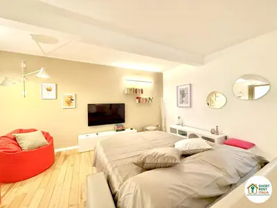 a bedroom with a large bed and a red chair at Colosseo - Venus House in Rome