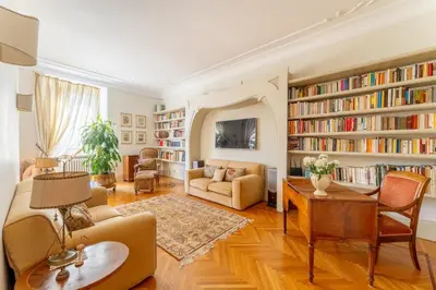 a living room with a lot of bookshelves at Luxury Suite Dante Elegante Appartamento di Lusso nel Cuore di Roma in Rome
