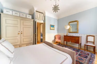 a bedroom with a bed and a desk and a mirror at Luxury Suite Dante Elegante Appartamento di Lusso nel Cuore di Roma in Rome