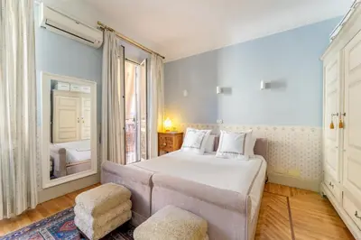 a bedroom with a large bed and a window at Luxury Suite Dante Elegante Appartamento di Lusso nel Cuore di Roma in Rome