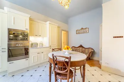 a kitchen with a table and chairs in a room at Luxury Suite Dante Elegante Appartamento di Lusso nel Cuore di Roma in Rome