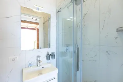 a bathroom with a sink and a shower at Constance Terrace Apartment by Rental in Rome in Rome