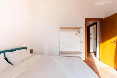 a bedroom with a large white bed and a closet at Domus Sabelli in Rome