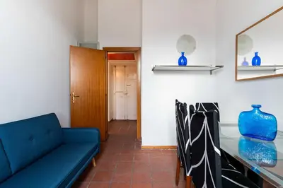 a living room with a blue couch and a table at Domus Sabelli in Rome