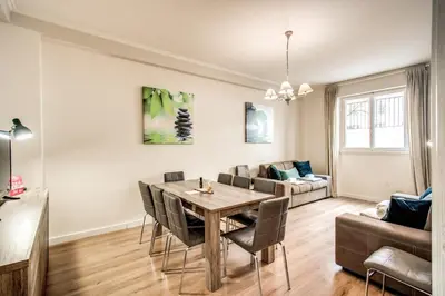 a living room with a table and chairs and a couch at Large Apartment in San Giovanni A in Rome