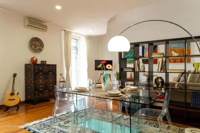 a living room with a glass table and a guitar at Trastevere Art House & terrace in Rome