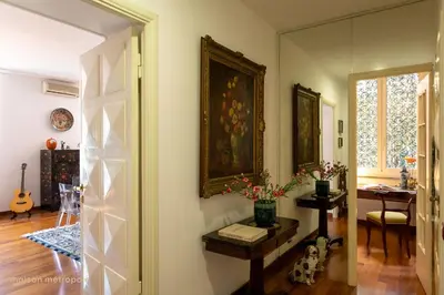 a living room with a table and a painting on the wall at Trastevere Art House & terrace in Rome