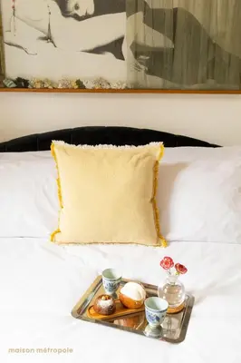 a tray of food on a bed with a pillow at Trastevere Art House & terrace in Rome