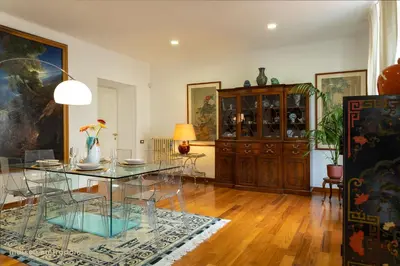 a living room with a glass table and a cabinet at Trastevere Art House & terrace in Rome