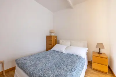 a bedroom with a bed and a night stand with a lamp at Piazza Navona Rooftop Retreat S in Rome