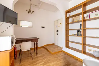 a dining room with a table and a television at Piazza Navona Rooftop Retreat S in Rome