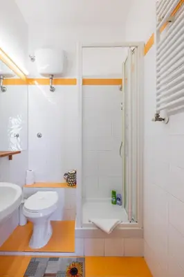 a white bathroom with a shower and a toilet at Piazza Navona Rooftop Retreat S in Rome