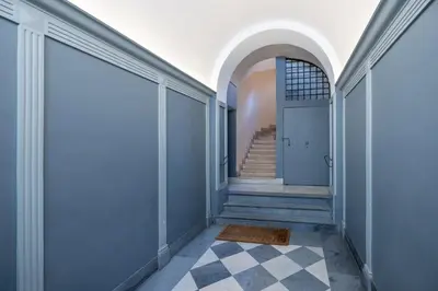 a hallway with a blue door and a checkered floor at Piazza Navona Rooftop Retreat S in Rome