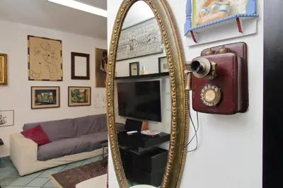 a mirror in a living room with a couch at Giuliana in Rome