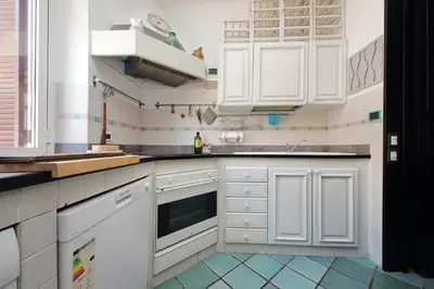 a kitchen with white cabinets and a sink at Giuliana in Rome