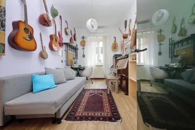 a living room with a couch and guitars on the wall at Giuliana in Rome