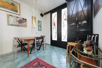 a room with a table and chairs and a black door at Giuliana in Rome