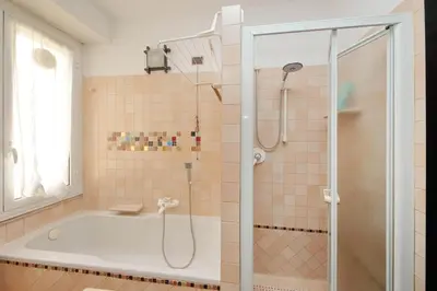 a bathroom with a tub and a shower stall at Giuliana in Rome