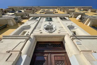 a building with a wooden door in the middle at Nomentana Home in Rome