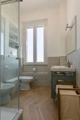 a bathroom with a toilet and a sink and a shower at Nomentana Home in Rome