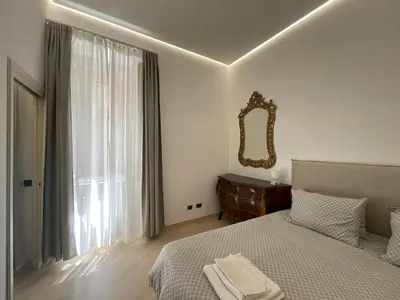a bedroom with a bed and a mirror on the wall at Appartamento Porto di Ripetta in Rome