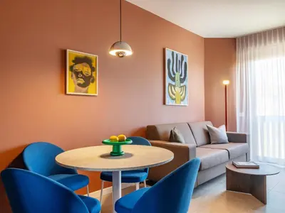 a living room with a couch and a table and chairs at Numa Rome Trastevere in Rome