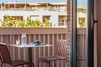 a table and chairs on a balcony with a building at Numa Rome Trastevere in Rome