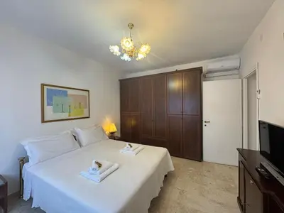 a bedroom with a white bed and a television at Rome in Retro Style in Rome