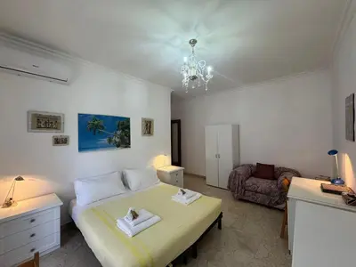 a bedroom with a bed and a chair in it at Rome in Retro Style in Rome