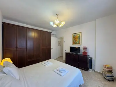 a bedroom with a white bed and a television at Rome in Retro Style in Rome