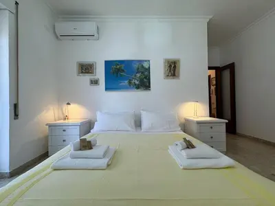 a large white bedroom with two beds and two lamps at Rome in Retro Style in Rome