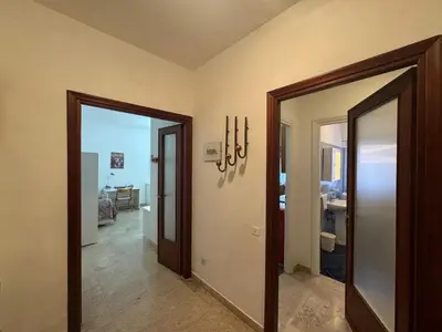 a hallway with two doors leading to a room at Rome in Retro Style in Rome