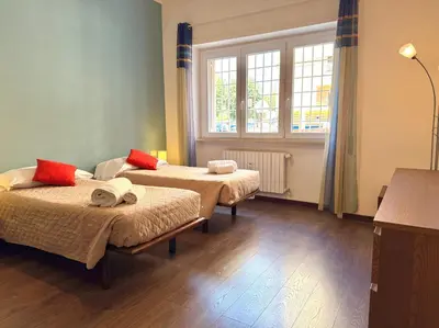 a room with two beds and a window at Oasi Majorana in Rome
