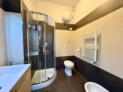 a bathroom with a shower and a toilet and a sink at Oasi Majorana in Rome