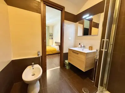 a bathroom with a sink and a toilet and a mirror at Oasi Majorana in Rome